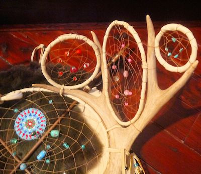 detail of turkey feathers and crow beads on dreamcatcher shield