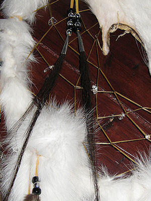 detail of horse hair and quartz crystals in web on white fox dreamcatcher